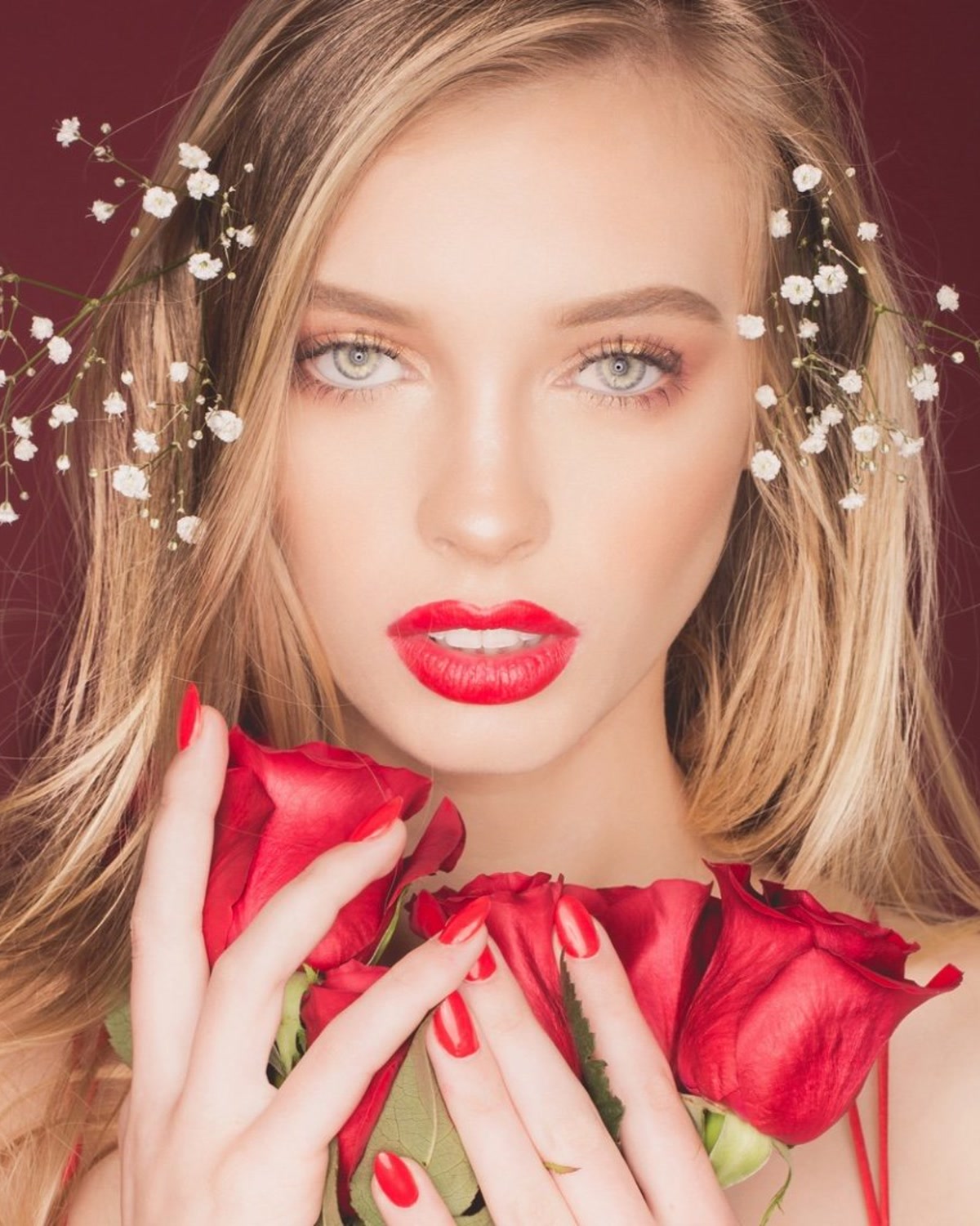 Julia Miller with bold red lipstick, roses, and soft glam makeup